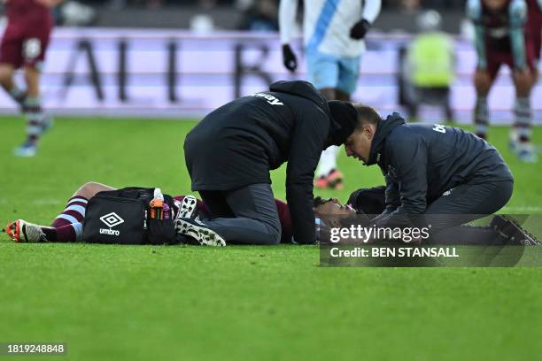 West Ham United's Brazilian midfielder Lucas Paqueta is treated after suffering an injury during the English Premier League football match between...