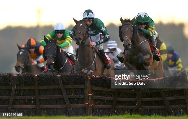Meath , Ireland - 3 December 2023; Common Practice, right, with Mark Walsh up, jumps the last on their way to winning the Bar One Racing Handicap...