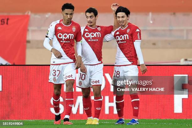 Monaco's French forward Wissam Ben Yedder celebrates after scoring his team's second goal with teammates Monaco's French midfielder Edan Diop and...