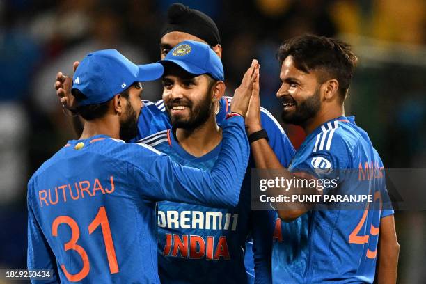India's Mukesh Kumar celebrates with teammates after taking the wicket of Australia's Ben Dwarshuis during the fifth and final Twenty20 international...
