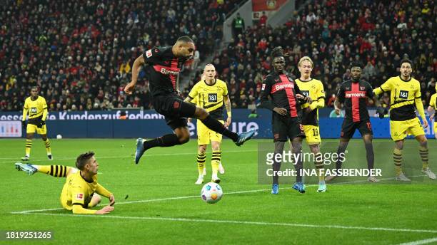 Bayer Leverkusen's German defender Jonathan Tah and Dortmund's German defender Nico Schlotterbeck vie for the ball during the German first division...