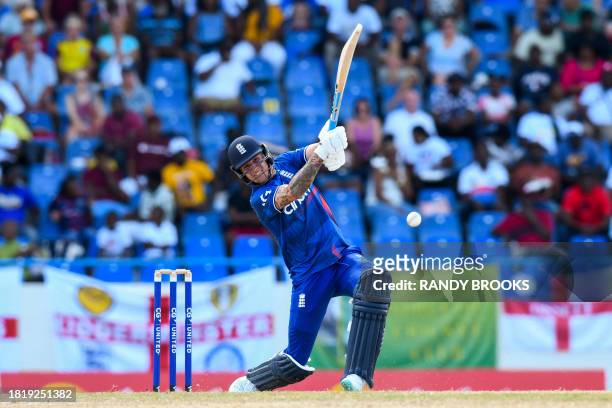 Brydon Carse, of England, hits 4 during the first one day international cricket match between England and West Indies at Sir Vivian Richards Stadium...