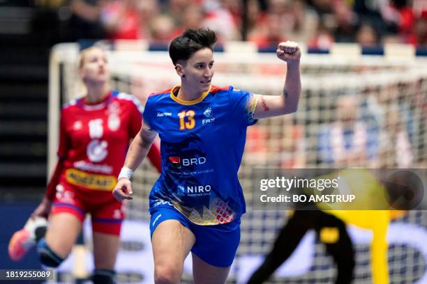Romania's centre back Cristina Laszlo celebrates during the preliminary round Group E match between Romania and Serbia of the IHF World Women's...