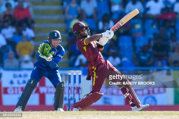 Jos Buttler , of England, looks on as Shai Hope , of West Indies, hits 6 during the first one day international cricket match between England and...