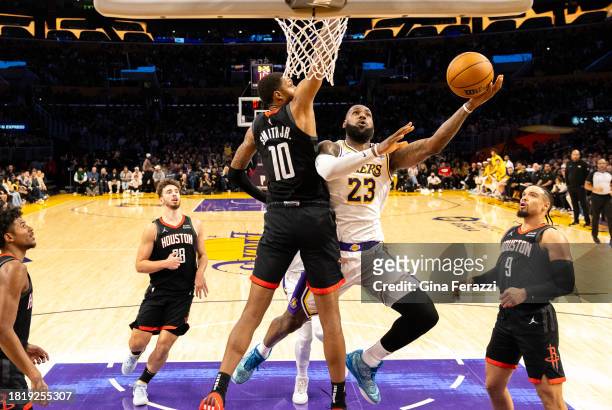 Los Angeles Lakers forward LeBron James drives to the basket to score against Houston Rockets forward Jabari Smith Jr. In the second quarter at...