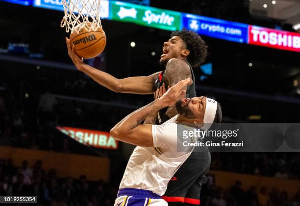Los Angeles Lakers forward Anthony Davis reacts as he gets elbowed in the face by Houston Rockets guard Jalen Green in the first quarter at...