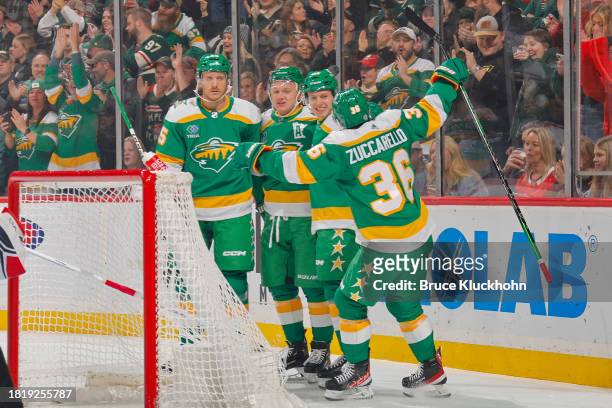 Jonas Brodin, Kirill Kaprizov, Connor Dewar and Mats Zuccarello of the Minnesota Wild celebrate a goal against the Chicago Blackhawks during the game...