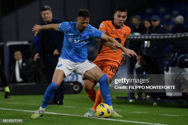 Napoli's Kosovo defender Amir Rrahmani fights for the ball with Inter Milan's Argentine forward Lautaro Martinez during the Italian Serie A football...