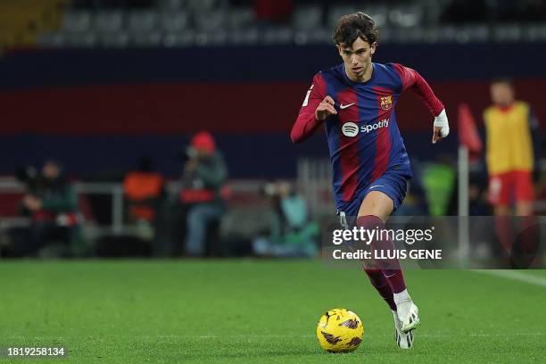 Barcelona's Portuguese forward Joao Felix dribbles the ball during the Spanish league football match between FC Barcelona and Club Atletico de Madrid...