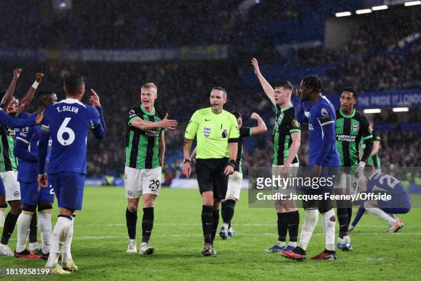 Both teams argue with match referee Craig Pawson during the Premier League match between Chelsea FC and Brighton & Hove Albion at Stamford Bridge on...