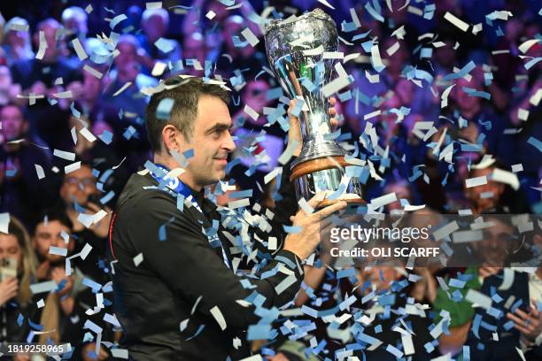 England's Ronnie O'Sullivan poses with the trophy after his victory over China's Ding Junhui in the final of the 2023 MrQ UK Championship at the York...