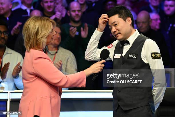 China's Ding Junhui gives an interview after his defeat to England's Ronnie O'Sullivan in the final of the 2023 MrQ UK Championship at the York...