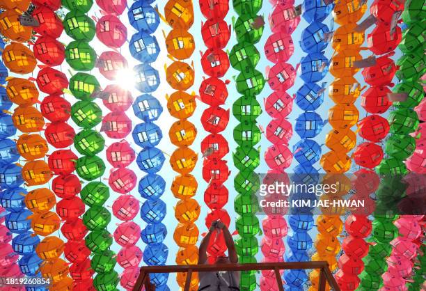 Buddhist follower hanks name tags of those who donated money and lotus lanterns at Chogye Temple in central Seoul on May 1, 2008. The temple is...