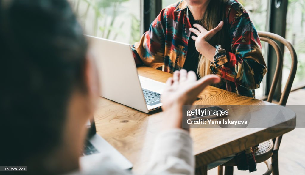 Unrecognizable people in the middle of a dynamic brainstorm an argument