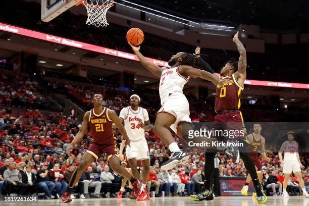 Bruce Thornton of the Ohio State Buckeyes drives to the basket while being defended by Elijah Hawkins of the Minnesota Golden Gophers during the...
