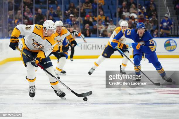 Cole Smith of the Nashville Predators controls the puck into the offensive zone during an NHL game against the Buffalo Sabres on December 3, 2023 at...