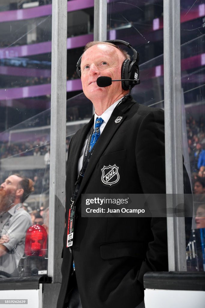 Neil Slawson NHL Off-Ice Official looks on prior to the game between...