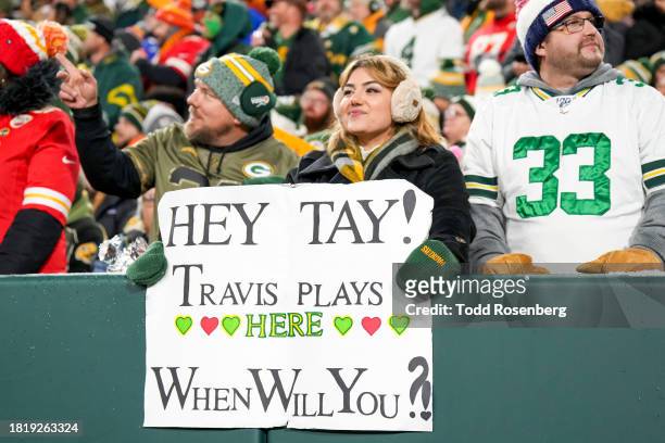 Fan of the Green Bay Packers holds up a sign for Taylor Swift during an NFL football game against the Kansas City Chiefs at Lambeau Field on December...