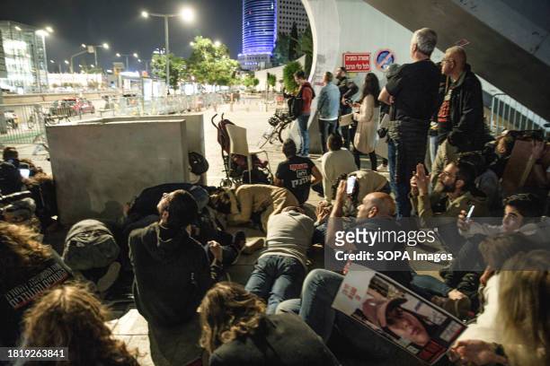 Hostages families and protesters take shelter below a bridge during a rocket attack on Tel Aviv. Thousands of Israelis joined the Hostages Families...