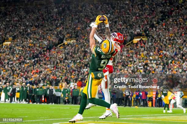 Wide receiver Christian Watson of the Green Bay Packers jumps up for a touch down during an NFL football game against the Kansas City Chiefs at...