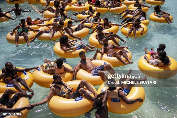 Vacationers gather while floating on inflatable donuts at a water park in Bishoftu on December 3, 2023. Just 40 kilometres outside Addis Ababa in the...