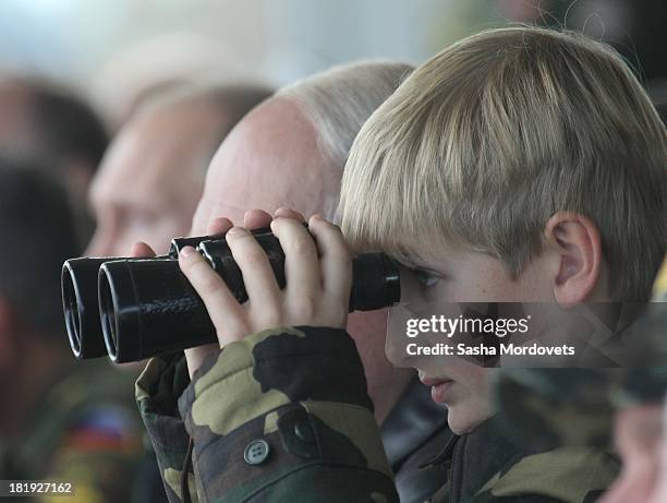 Belarussian President Alexander Lukashenko and his son Nikolai watch joint Russian-Belarussian military exercises at the polygon on September 26,...