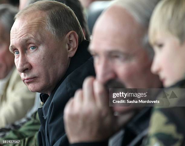 Russian President Vladimir Putin , Belarussian President Alexander Lukashenko and his son Nikolai watch joint Russian-Belarussian military exercises...