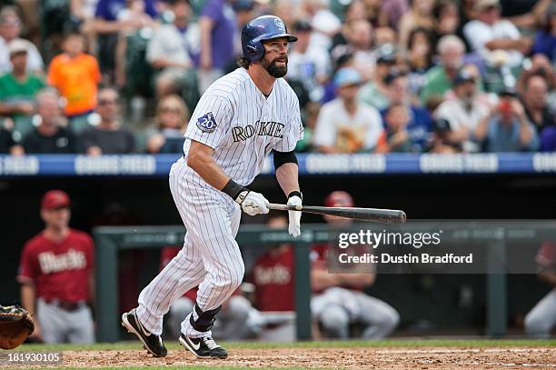 Todd Helton of the Colorado Rockies hits a fourth inning double against the Arizona Diamondbacks during a game at Coors Field on September 22, 2013...