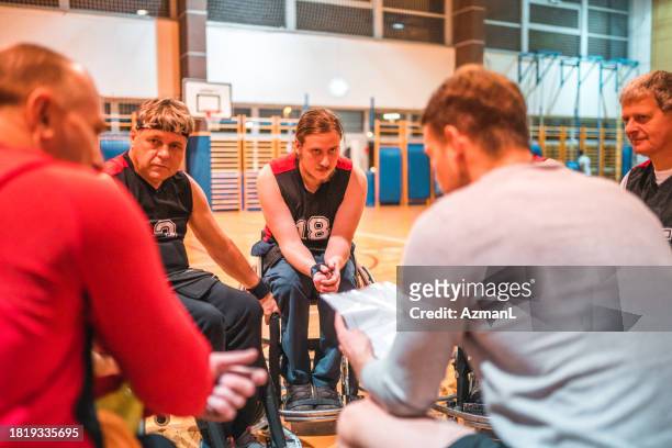 coach detailing strategy for wheelchair basketball team - basketball player close up stock pictures, royalty-free photos & images