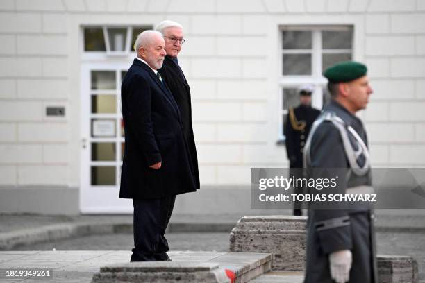 German President Frank-Walter Steinmeier and Brazilian President Luiz Inacio Lula da Silva watch a soldier of the German Bundeswehr's honour guard...