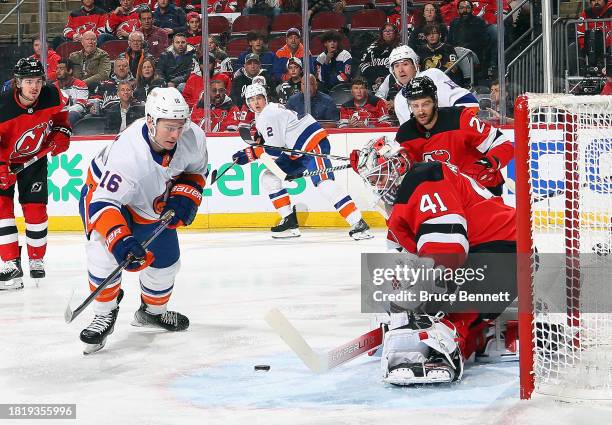 Julien Gauthier of the New York Islanders attempts to get off a first period shot against Vitek Vanecek of the New Jersey Devils at Prudential Center...