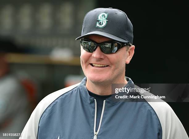 Manager Eric Wedge of the Seattle Mariners looks on from the dugout and smiles during the game against the Detroit Tigers at Comerica Park on...