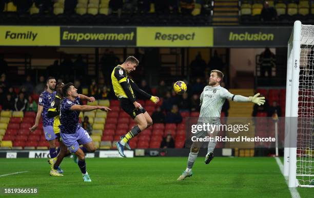 Mileta Rajovic of Watford scores the team's second goal past George Long of Norwich City during the Sky Bet Championship match between Watford and...