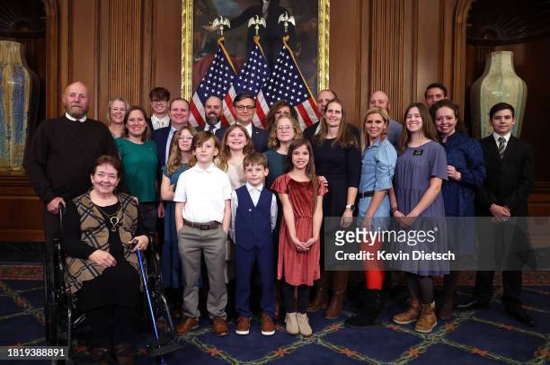 Speaker of the House Mike Johnson poses with Rep. Celeste Maloy and her family during a photo-op for her ceremonial swearing-in at the U.S. Capitol...