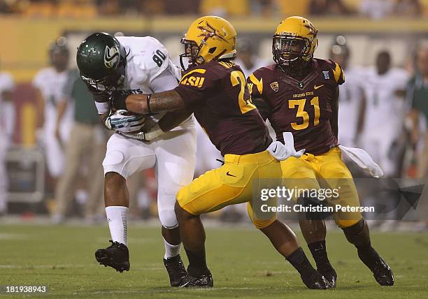 Tight end Chris Broadnax of the Sacramento State Hornets runs with the football against linebackers Steffon Martin and Anthony Jones of the Arizona...