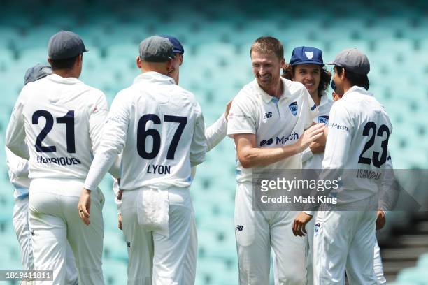 Jackson Bird of New South Wales celebrates with team mates after taking the wicket of Caleb Jewell of the Tigers during the Sheffield Shield match...