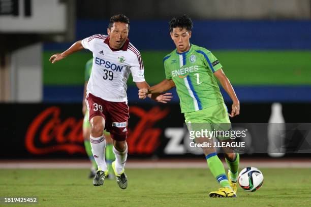 Shunsuke Kikuchi of Shonan Bellmare controls the ball against Yoshiro Abe of Matsumoto Yamaga during the J.League J1 second stage match between...