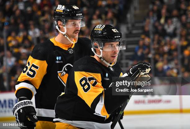 Erik Karlsson skates alongside Sidney Crosby of the Pittsburgh Penguins during the game against the New York Rangers at PPG PAINTS Arena on November...