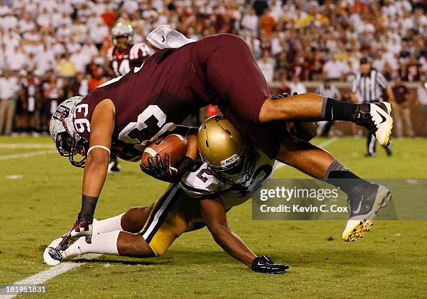 Jabari Hunt-Days of the Georgia Tech Yellow Jackets tackles Kalvin Cline of the Virginia Tech Hokies at Bobby Dodd Stadium on September 26, 2013 in...