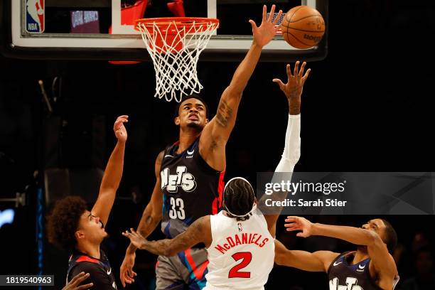 Nic Claxton of the Brooklyn Nets blocks a shot by Jalen McDaniels of the Toronto Raptors during the second half of an NBA In-Season Tournament game...