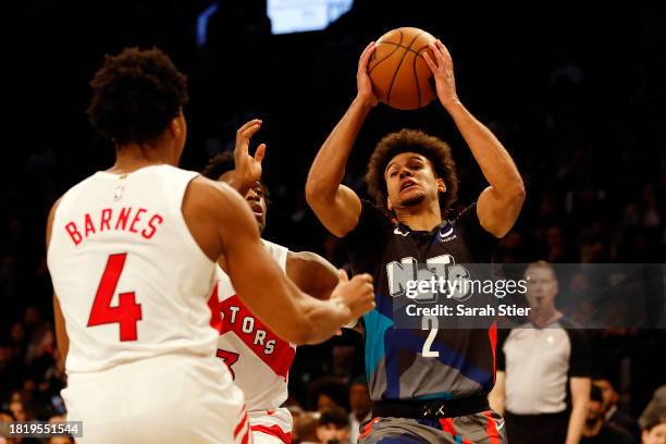 Cameron Johnson of the Brooklyn Nets goes to the basket as Scottie Barnes and O.G. Anunoby of the Toronto Raptors defend during the second half of an...
