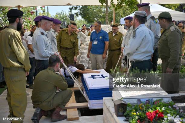 The mother of Col. Asaf Hamami, commander of Gaza Division’s Southern Brigade, grieves during his funeral at the Kiryat Shaul cemetery on December 4,...