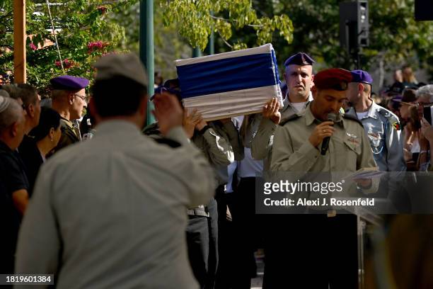 Mourners grieve for Col. Asaf Hamami, commander of Gaza Division’s Southern Brigade, during his funeral at the Kiryat Shaul cemetery on December 4,...