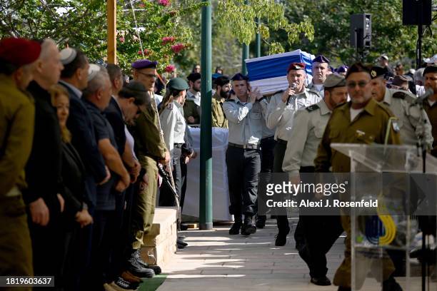 Mourners grieve for Col. Asaf Hamami, commander of Gaza Division’s Southern Brigade, during his funeral at the Kiryat Shaul cemetery on December 4,...