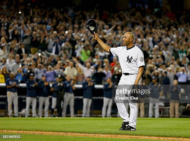 Mariano Rivera of the New York Yankees salutes the fans after he is pulled from the game in the ninth inning against the Tampa Bay Rays on September...