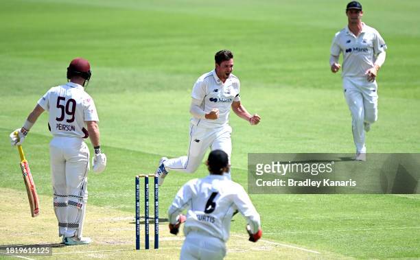 Jhye Richardson of Western Australia celebrates taking the wicket of Jimmy Peirson of Queensland during day two of the Sheffield Shield match between...