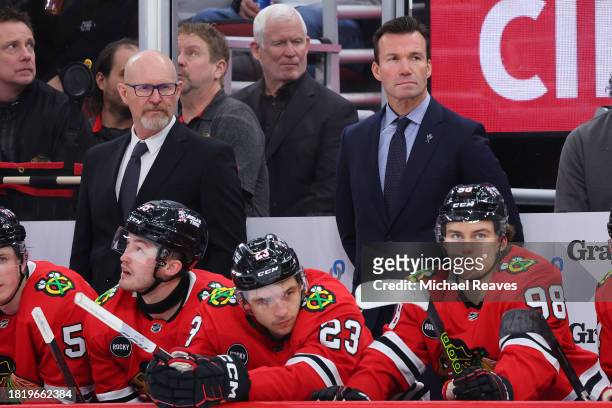 Assistant coach Derek King and head coach Luke Richardson of the Chicago Blackhawks look on against the Seattle Kraken during the third period at the...