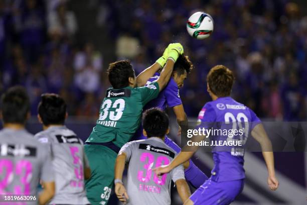 Toshihiro Aoyama of Sanfrecce Hiroshima and Akihiro Hayashi of Sagan Tosu compete for the ball during the J.League J1 second stage match between...