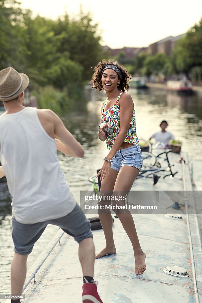 Young couple dancing on top of a canal boat