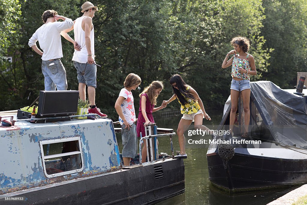 Young people getting on to canal boat